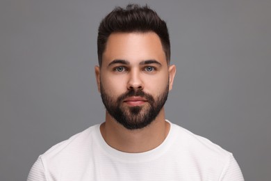 Portrait of young man on light grey background