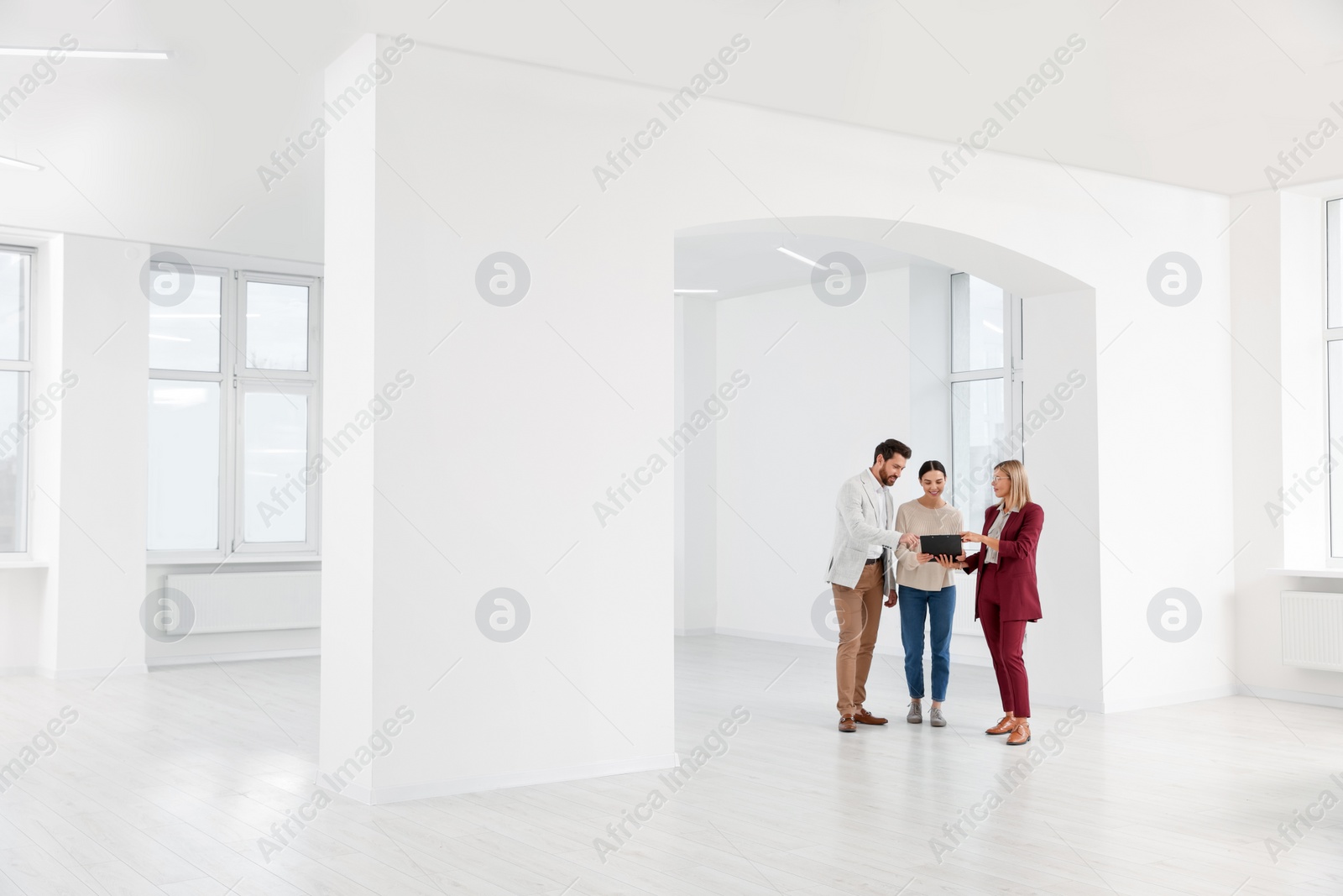 Photo of Real estate agent showing new apartment to couple