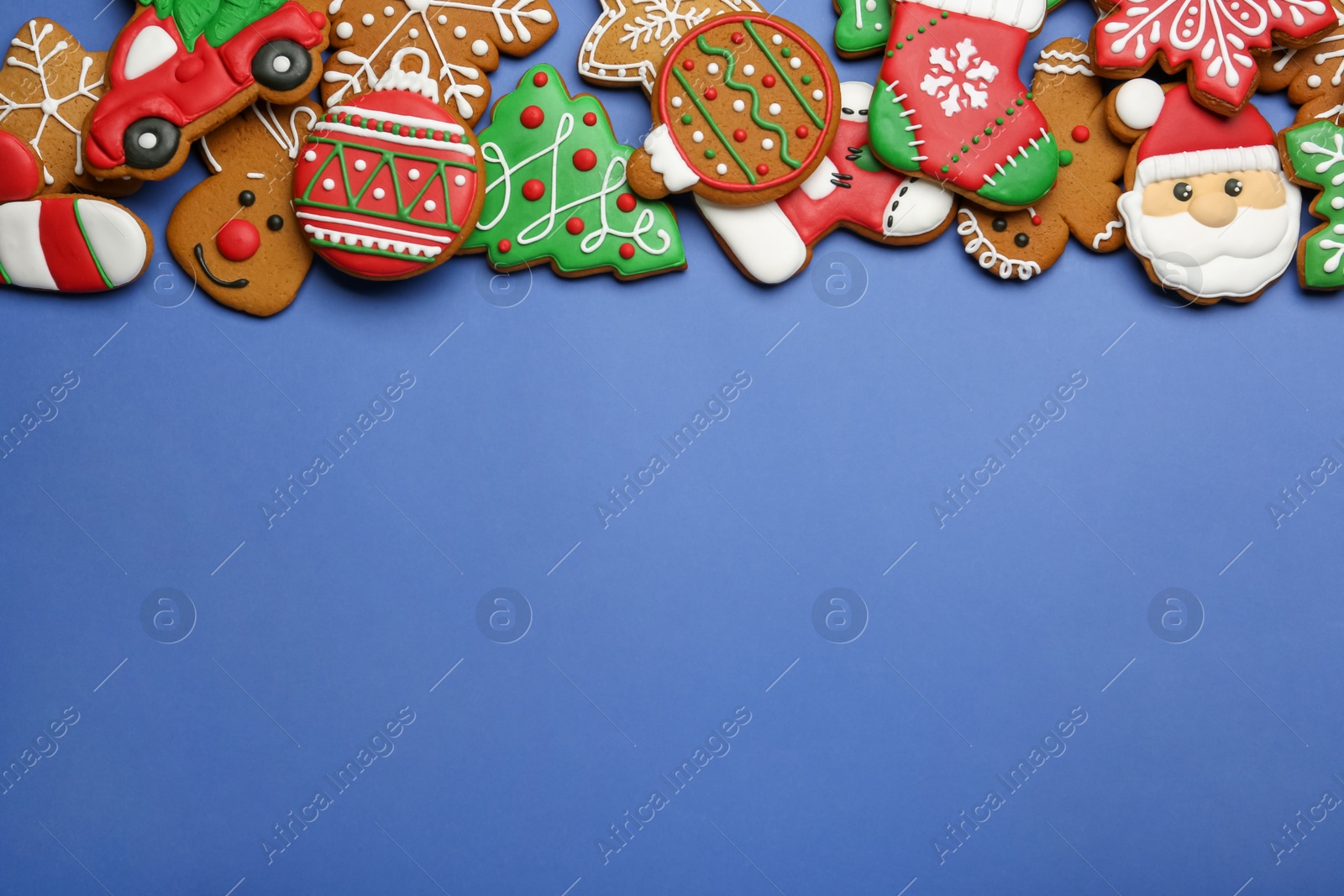 Photo of Different tasty Christmas cookies on blue background, flat lay. Space for text