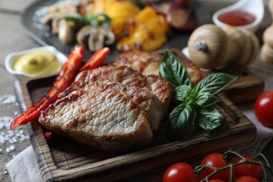 Photo of Delicious grilled meat and vegetables on table, closeup