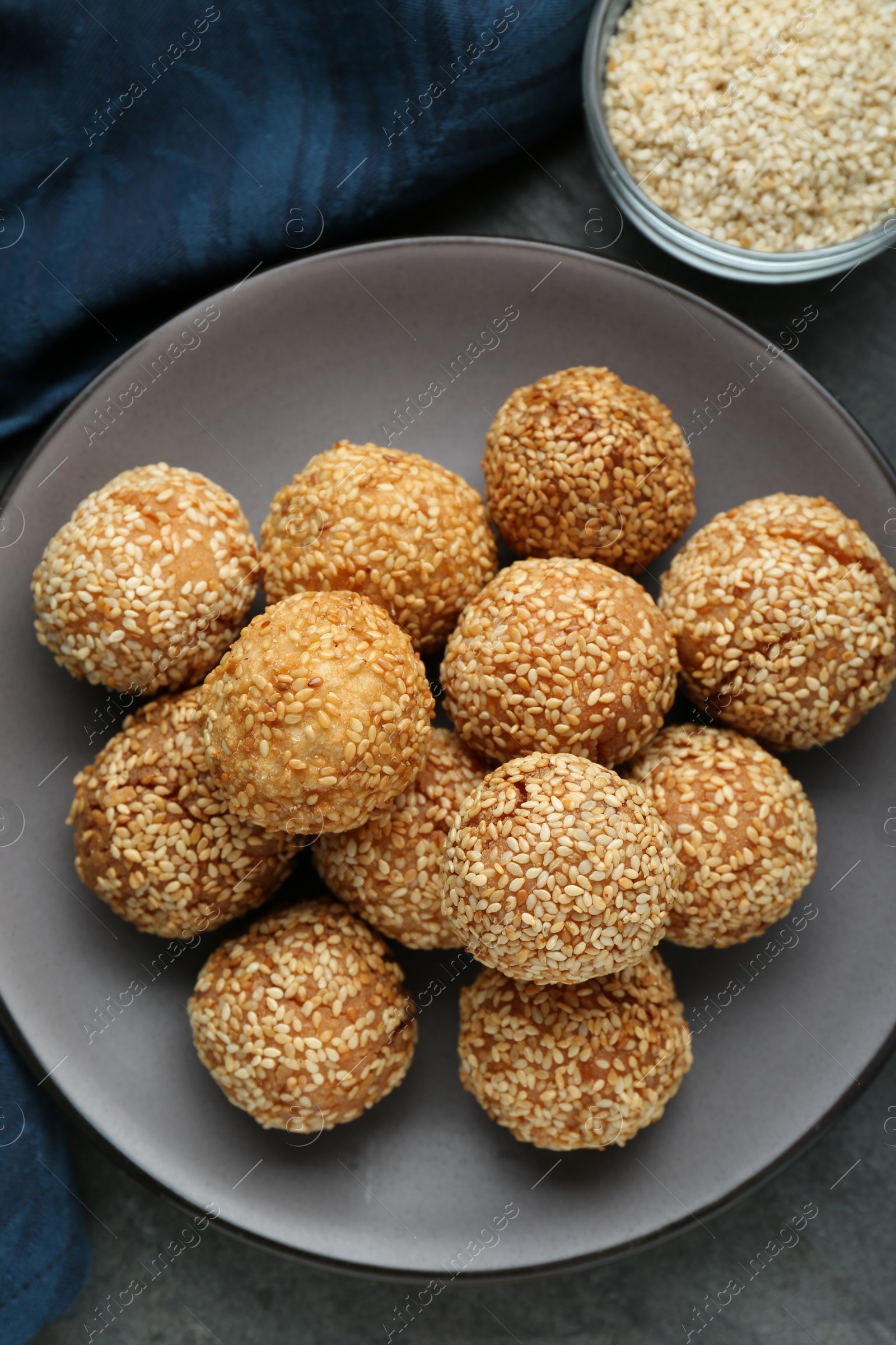 Photo of Delicious sesame balls on grey table, flat lay