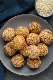 Photo of Delicious sesame balls on grey table, flat lay