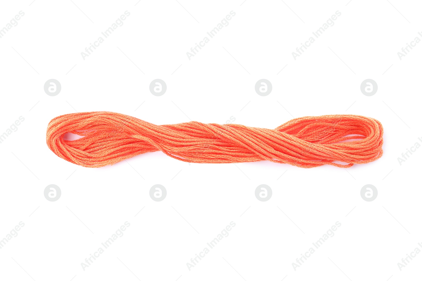 Photo of Bright coral embroidery thread on white background