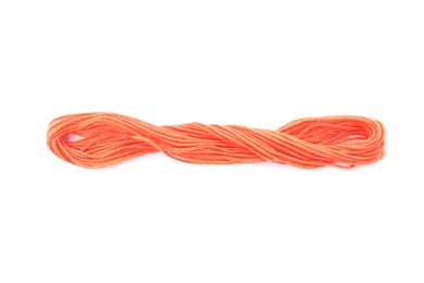 Photo of Bright coral embroidery thread on white background