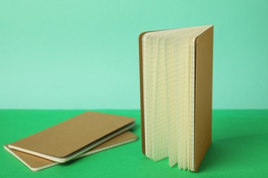 Photo of New stylish kraft planners on color background