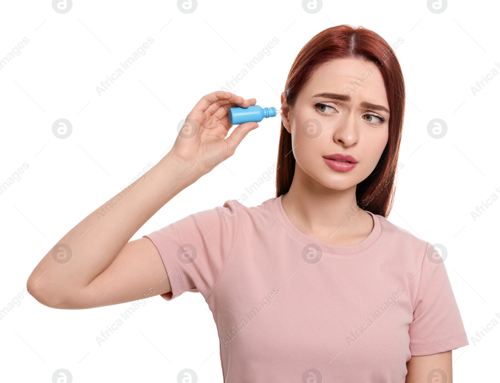 Photo of Unhappy woman using ear drops on white background