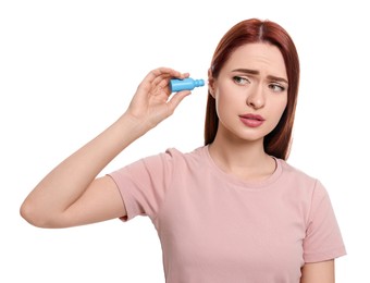 Photo of Unhappy woman using ear drops on white background