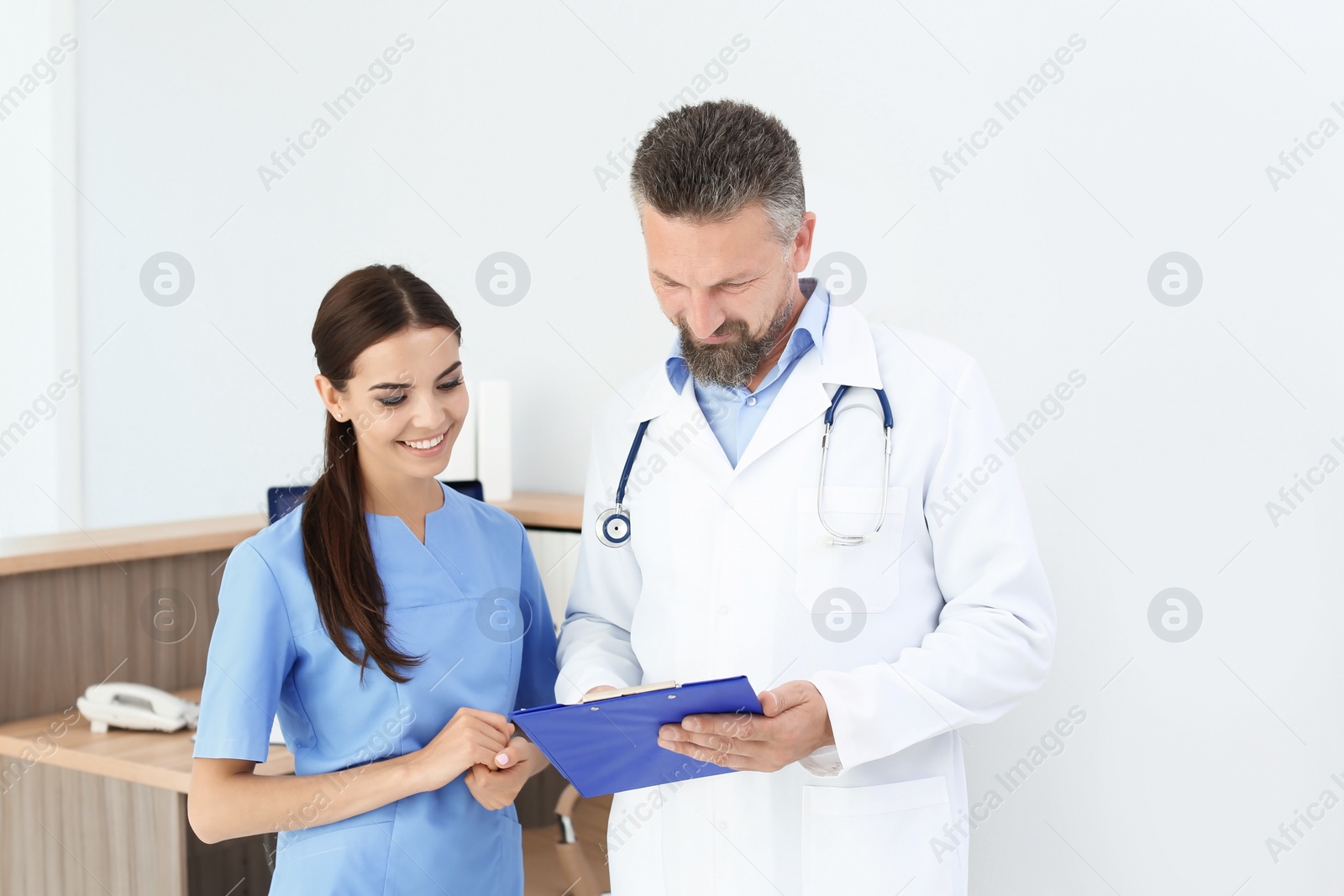 Photo of Doctor with medical assistant in clinic. Health care service