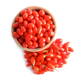 Photo of Fresh ripe goji berries and wooden bowl on white background, top view