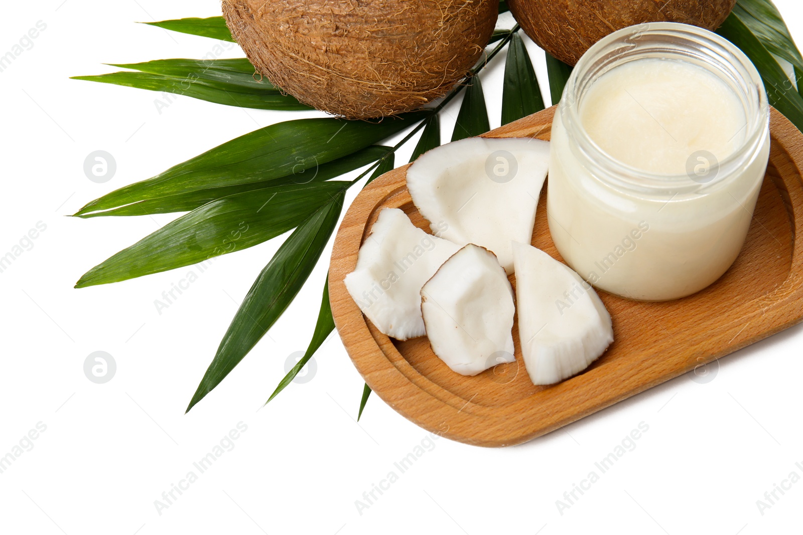 Photo of Jar with coconut oil and nuts on white background