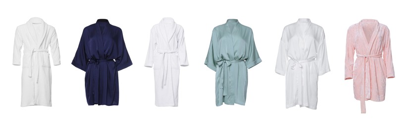 Set of different bathrobes on white background