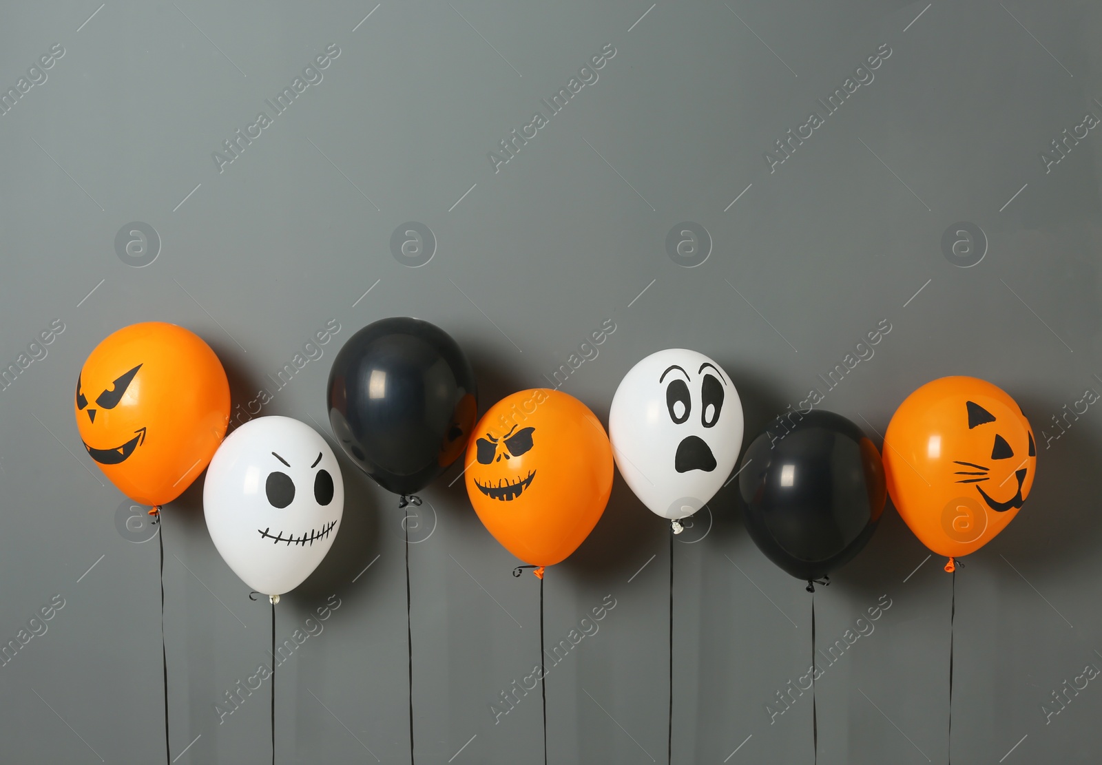 Photo of Color balloons for Halloween party on gray background. Space for text