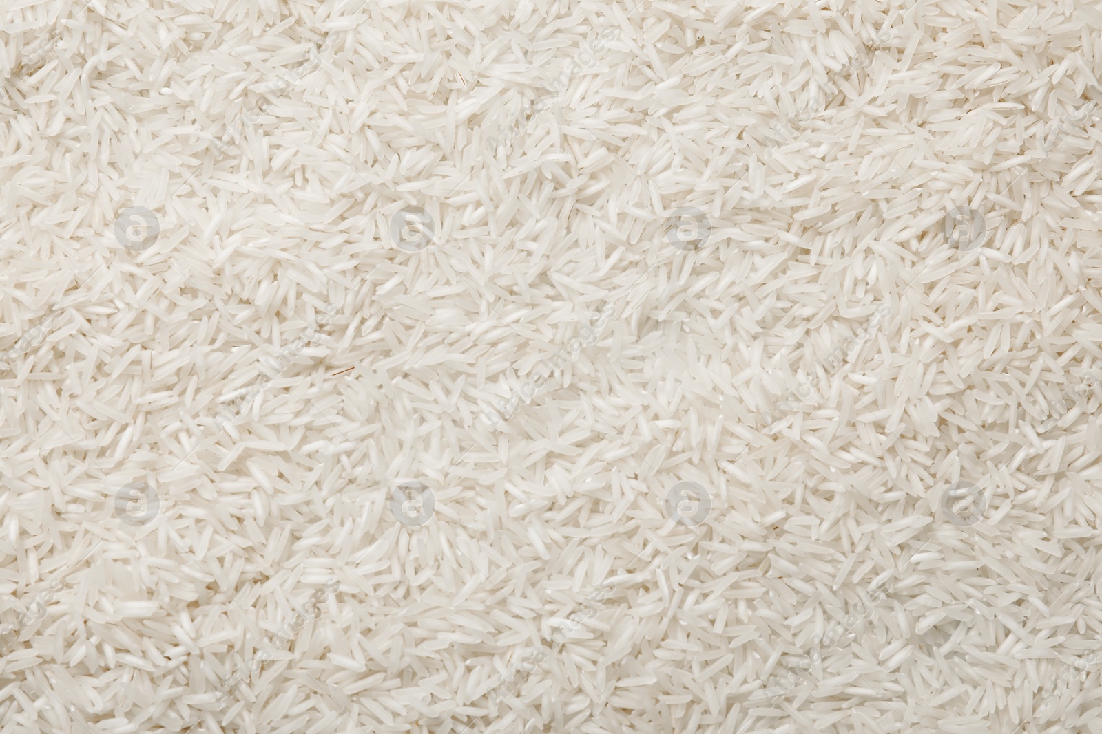 Photo of Raw basmati rice as background, top view