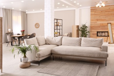 Photo of Modern living room interior with comfortable sofa and wooden table