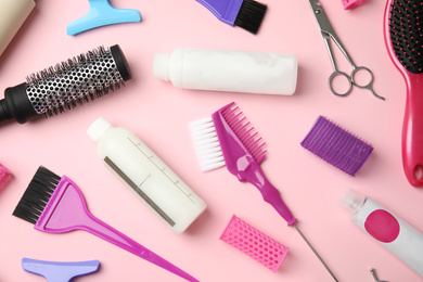 Photo of Professional tools for hair dyeing on pink background, flat lay