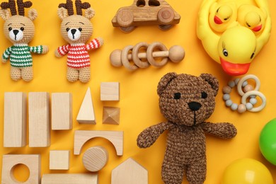 Photo of Different children's toys on yellow background, flat lay