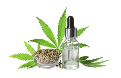 Bottle of CBD oil or THC tincture, hemp leaves and grains on white background