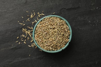 Photo of Fennel seeds in bowl on gray table, top view