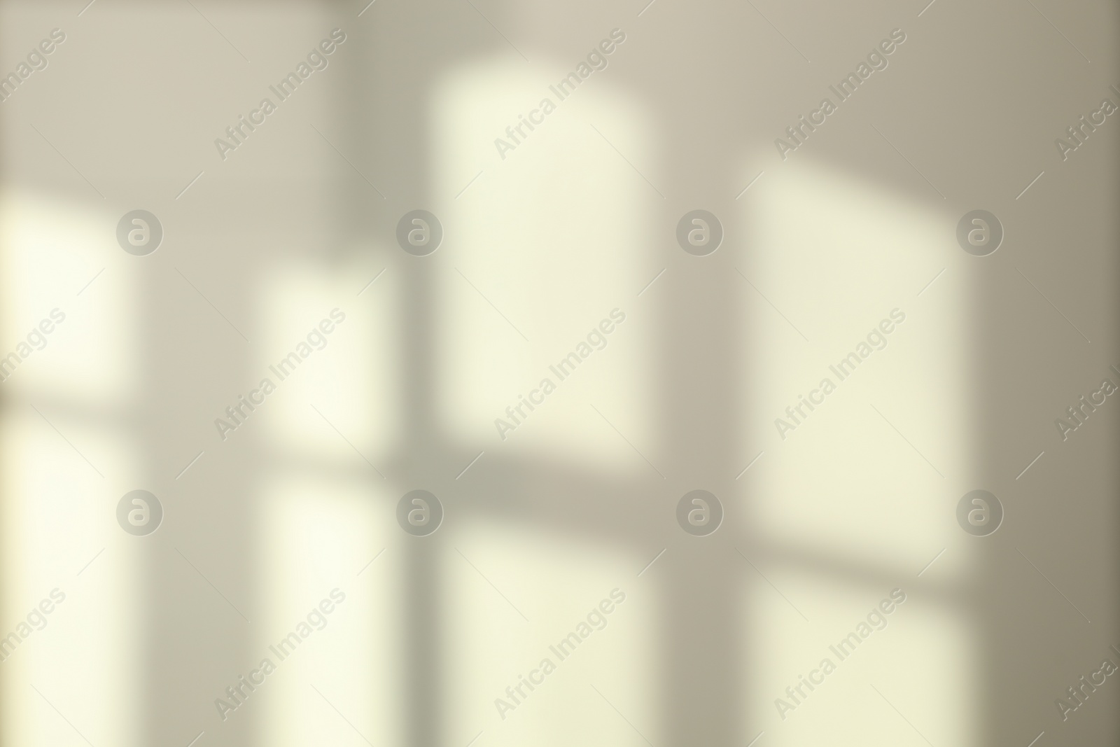 Photo of Light and shadows from window on wall indoors