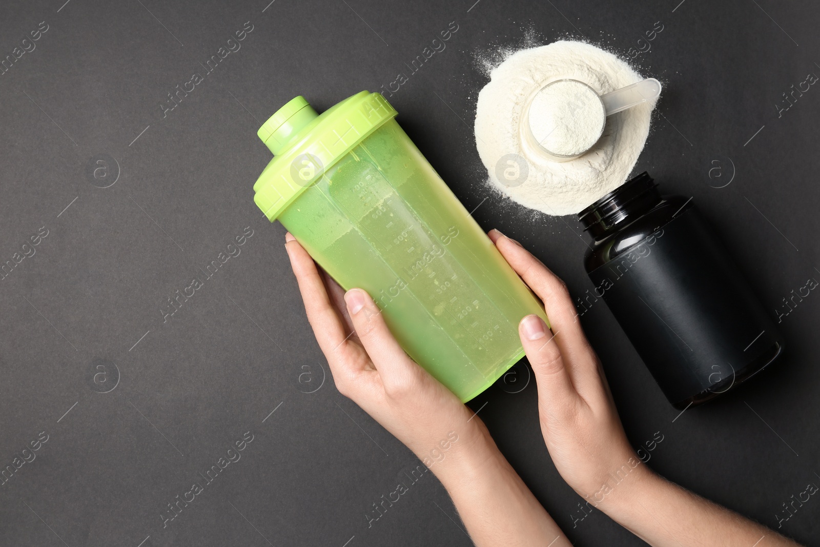 Photo of Woman with bottle of water, protein powder and space for text on black background, top view. Preparing shake