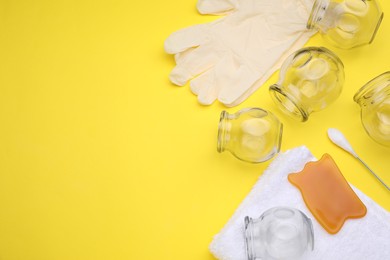 Photo of Flat lay composition with glass cups on yellow background, space for text. Cupping therapy