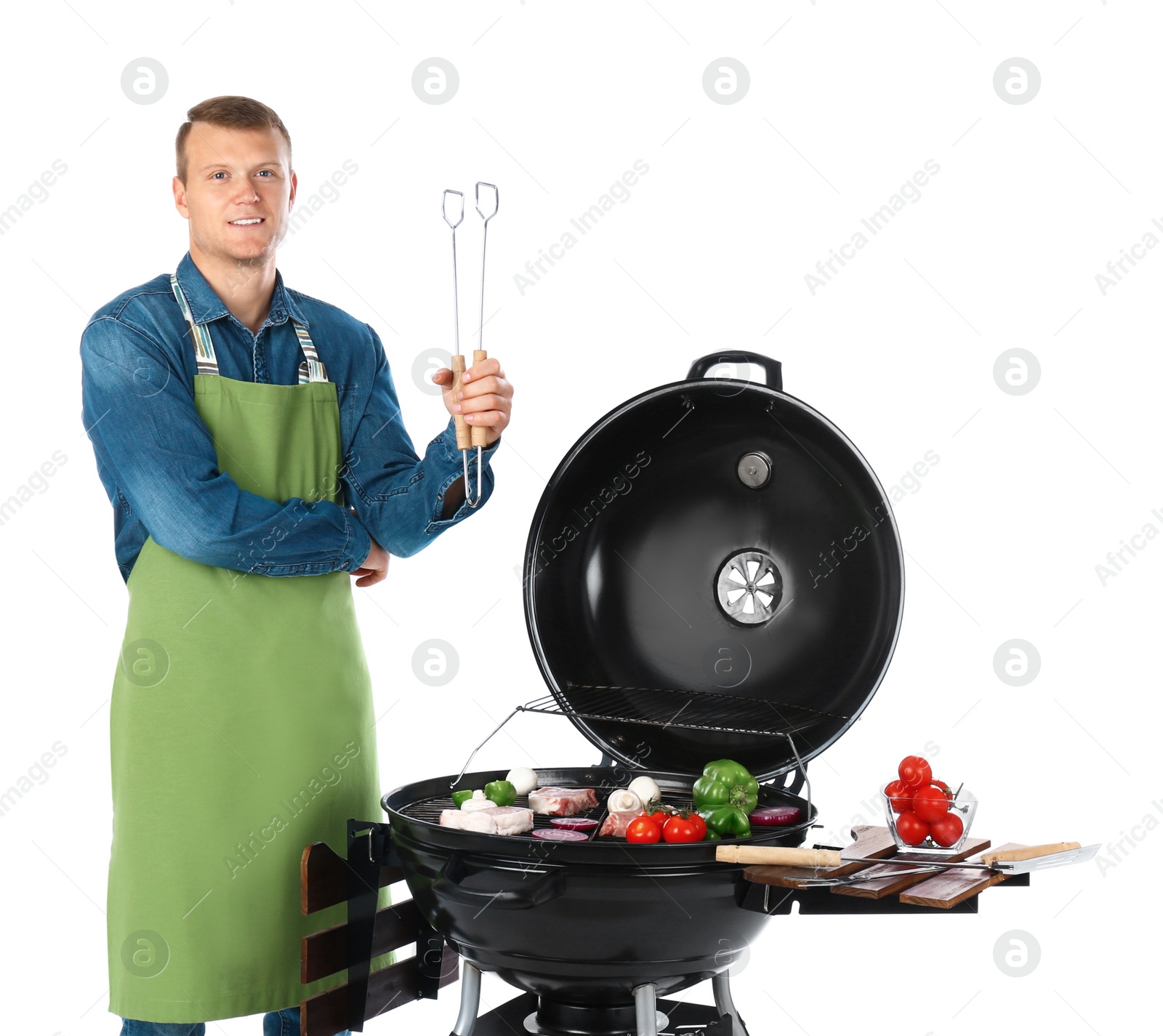 Photo of Man in apron cooking on barbecue grill, white background