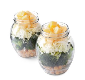 Photo of Healthy salad in glass jars isolated on white