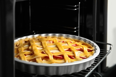 Photo of Traditional English apple pie on shelf of oven, closeup