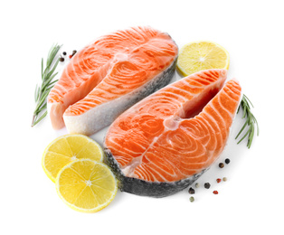 Photo of Fresh raw salmon with lemon, pepper and rosemary on white background. Fish delicacy