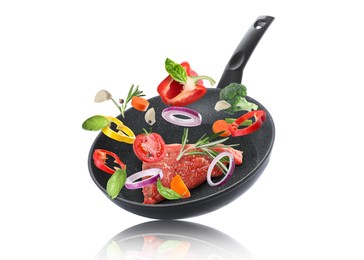 Image of Tasty fresh ingredients and frying pan on white background