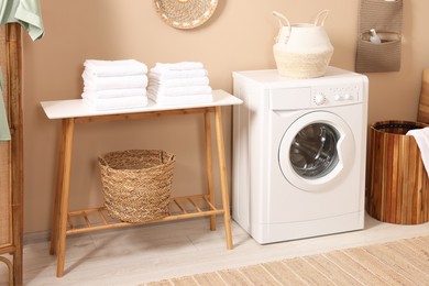 Stylish laundry room with modern washing machine. Interior design