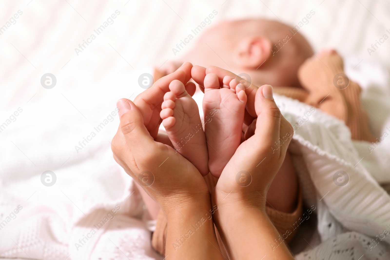 Photo of Mother and her newborn baby on bed, closeup. Space for text