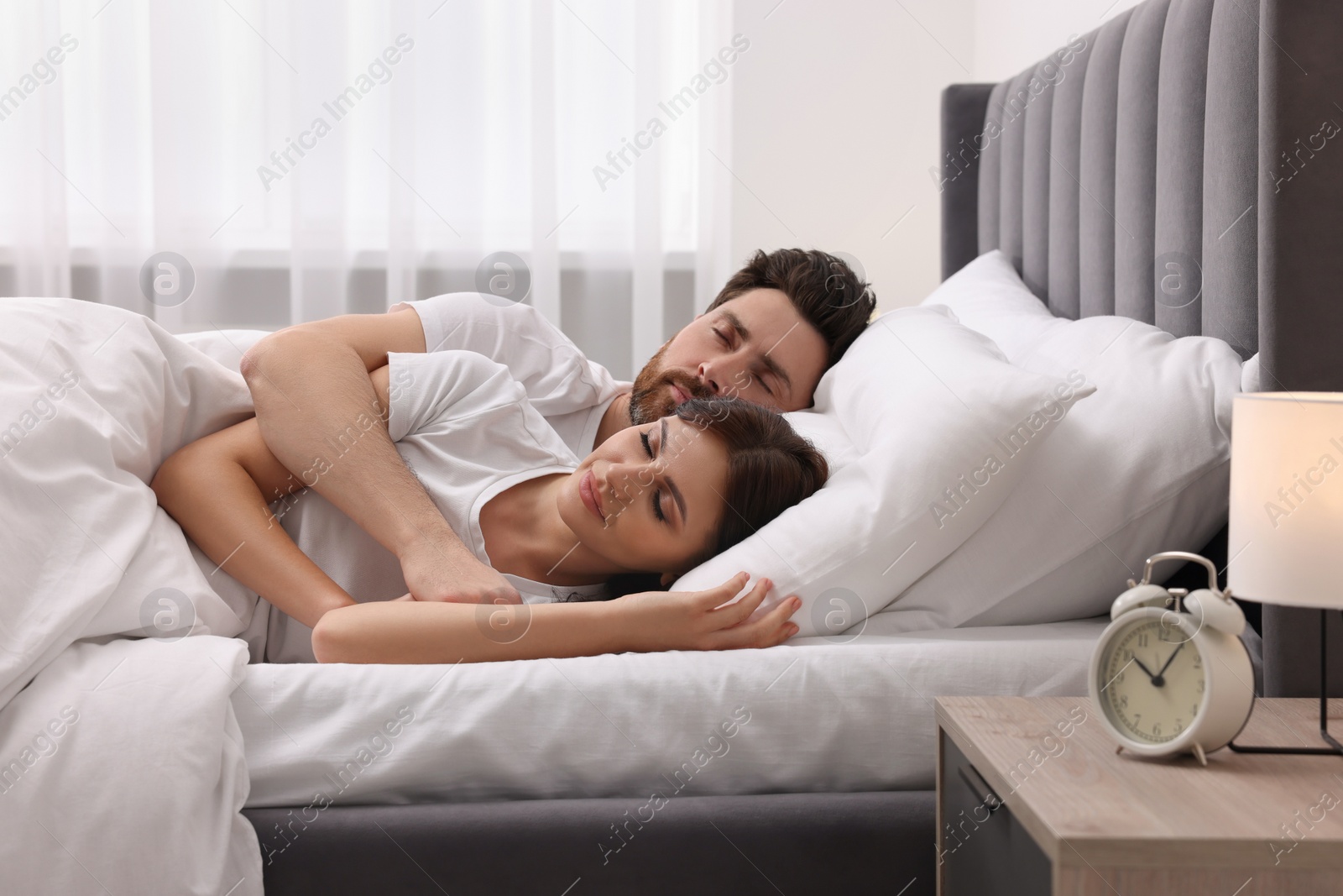 Photo of Lovely couple sleeping together in bed at home