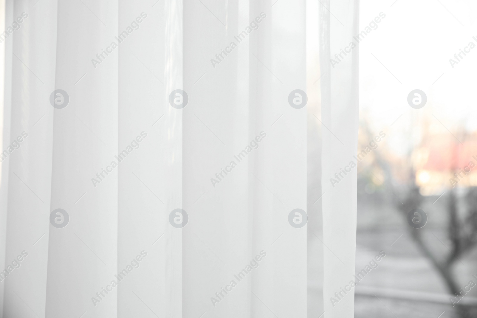 Photo of Window with white curtains indoors, closeup view