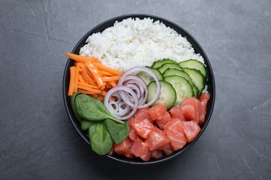 Photo of Delicious poke bowl with salmon and vegetables on grey table, top view