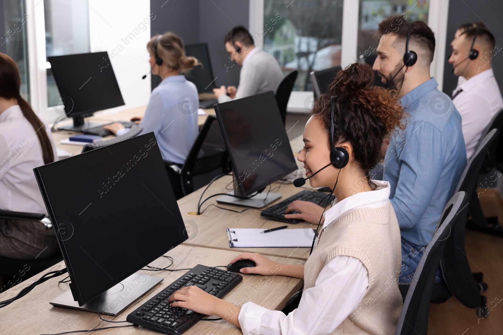 Photo of Call center operators working in modern office