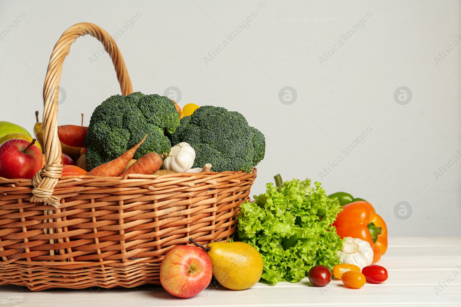 Photo of Assortment of fresh vegetables and fruits on white wooden table