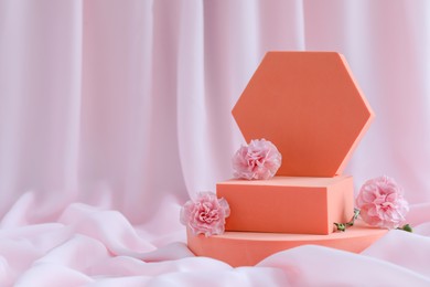 Photo of Geometric figures and roses on pink fabric, space for text. Stylish presentation for product