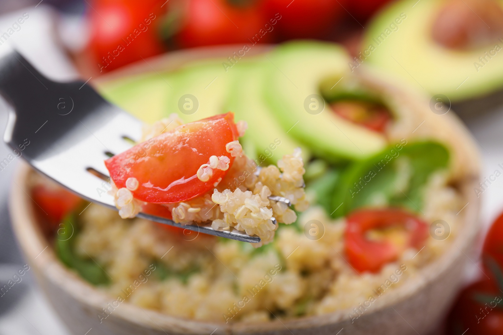 Photo of Fork with delicious quinoa salad, closeup view