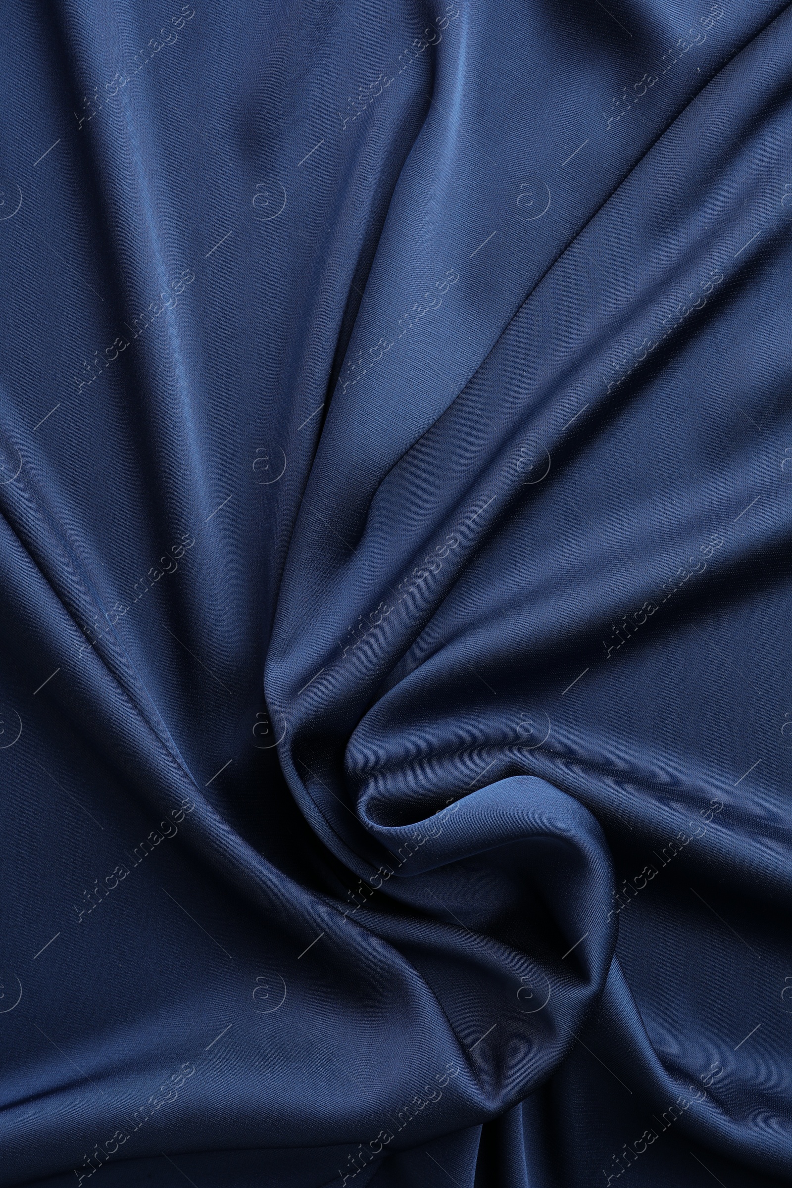 Photo of Texture of blue crumpled silk fabric as background, top view
