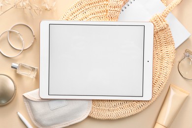 Photo of Flat lay composition with modern tablet on beige background. Space for text