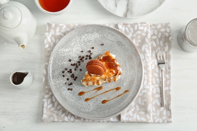 Piece of delicious homemade cake with caramel sauce on table, top view