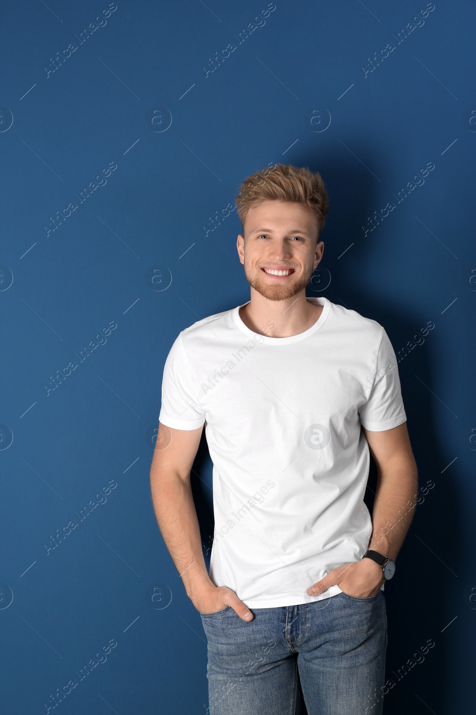 Photo of Portrait of handsome young man on blue background