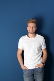 Portrait of handsome young man on blue background