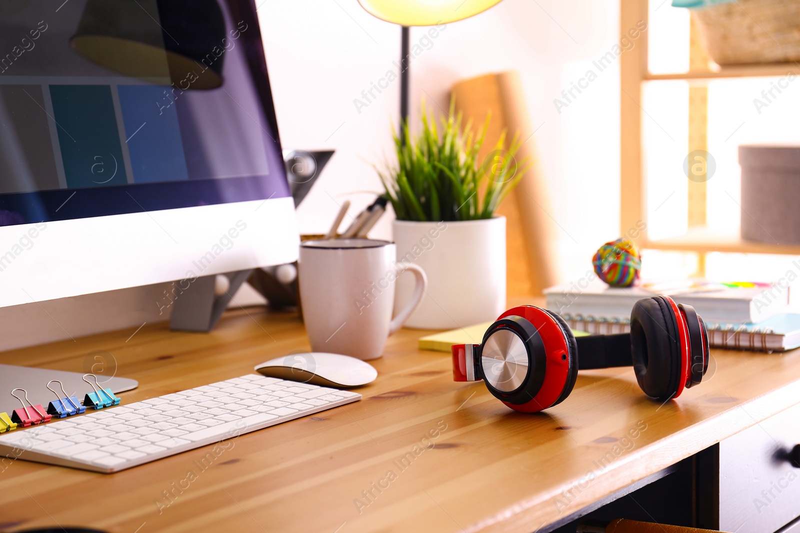 Photo of Headphones on table in studio. Modern designer's workplace