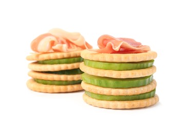Photo of Delicious crackers with cucumber and prosciutto on white background