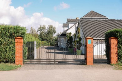 Photo of Metal gates near beautiful houses on sunny day