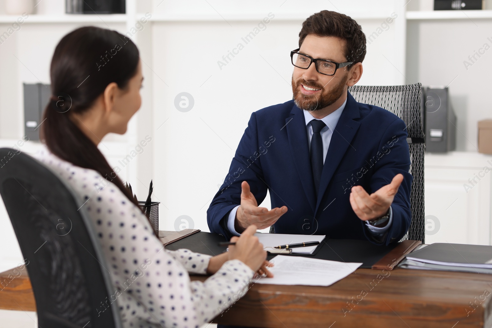 Photo of Woman having meeting with lawyer in office, selective focus