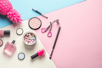 Flat lay composition with decorative cosmetics on color background