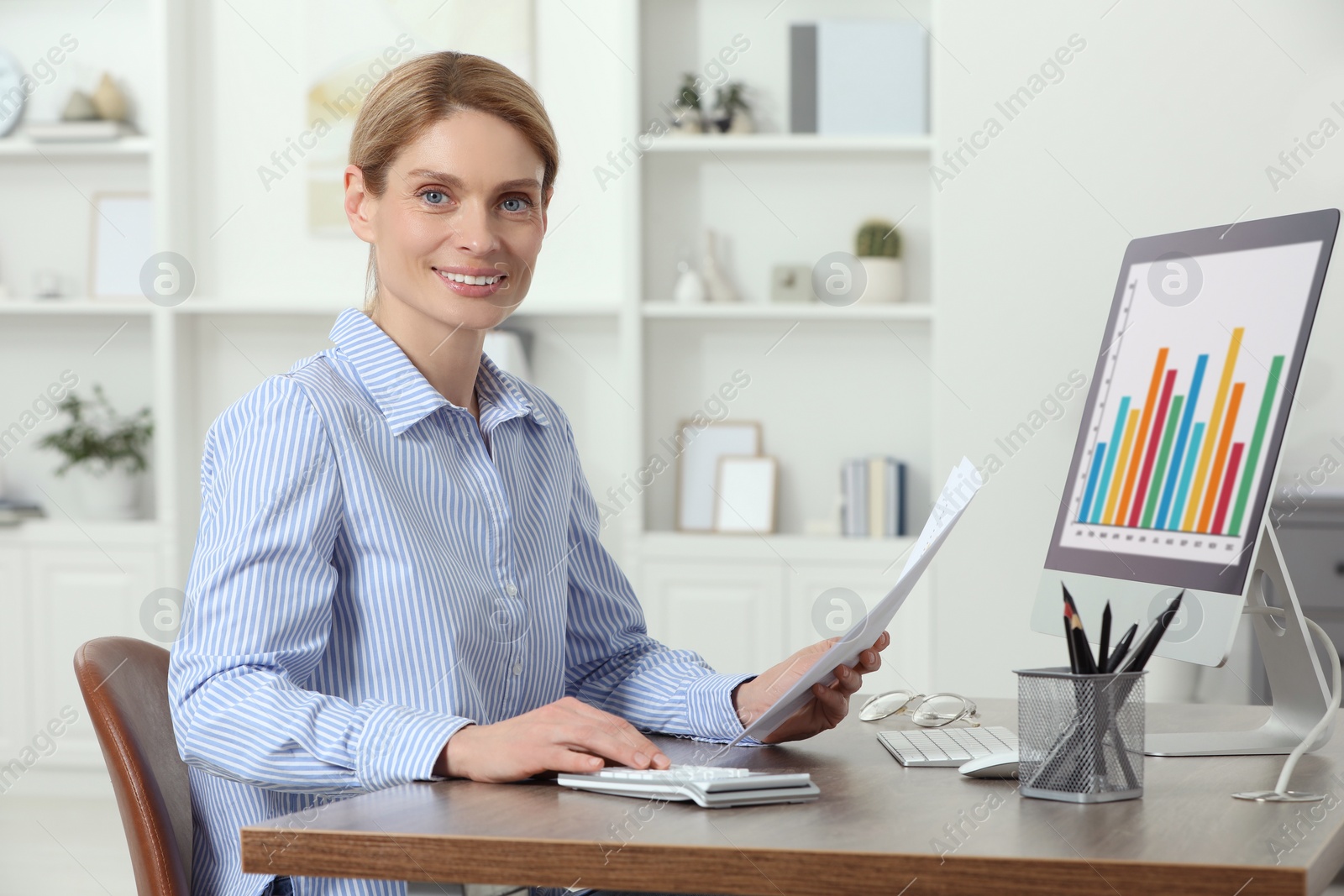 Photo of Professional accountant working at wooden desk in office